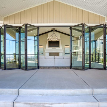 Gabled Poolside Pavilion Closes Behind a Full Wall of Folding Glass Doors