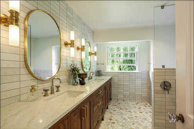 Inspiration for a large timeless master white tile and porcelain tile marble floor, multicolored floor and double-sink bathroom remodel in Portland with shaker cabinets, dark wood cabinets, white walls, an undermount sink, quartz countertops, white countertops, a niche and a built-in vanity