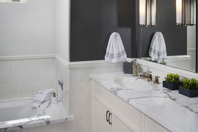 Inspiration for a mid-sized modern kids' white tile pebble tile floor bathroom remodel in San Francisco with an undermount sink, beaded inset cabinets, white cabinets, marble countertops and gray walls