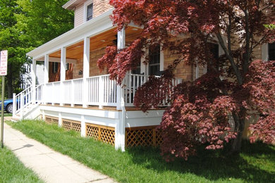 Mid-sized country front porch idea in DC Metro with a roof extension
