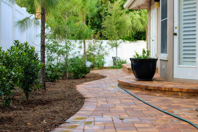 Mountain style backyard concrete paver patio photo in Tampa