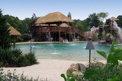 Hot tub - huge backyard custom-shaped hot tub idea in New York