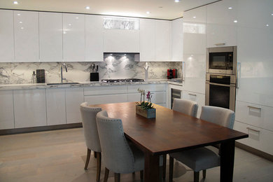 Example of a large trendy l-shaped eat-in kitchen design in New York with no island