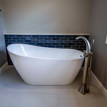 Primary Bathroom with Blue-Gray Vanity and Deep Blue Tiled Feature Wall
