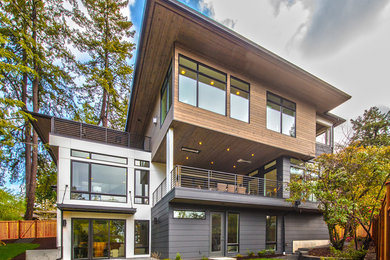 Large transitional multicolored two-story mixed siding exterior home photo in Seattle with a shingle roof