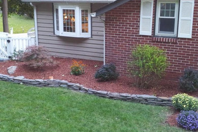 Inspiration for a large backyard stone landscaping in New York.