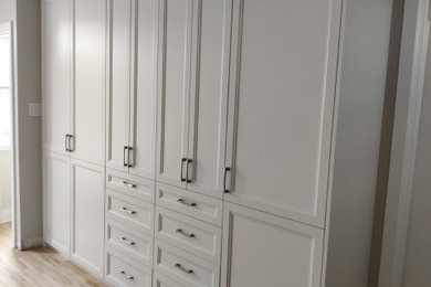 Bedroom - mid-sized modern master light wood floor bedroom idea in Montreal with beige walls
