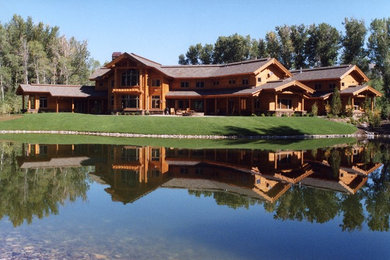 Example of a huge mountain style two-story wood gable roof design in Seattle