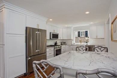 Mid-sized transitional l-shaped medium tone wood floor and brown floor eat-in kitchen photo in DC Metro with an undermount sink, shaker cabinets, white cabinets, quartz countertops, white backsplash, porcelain backsplash, stainless steel appliances, no island and yellow countertops