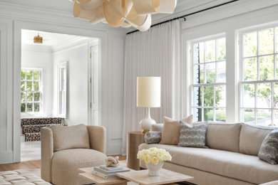 Example of a transitional medium tone wood floor, brown floor and wall paneling living room design in Atlanta with white walls