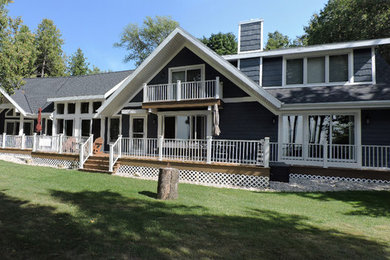 Example of a large transitional blue two-story mixed siding exterior home design in Other with a shingle roof