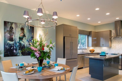Inspiration for a small contemporary l-shaped porcelain tile open concept kitchen remodel in San Francisco with an undermount sink, flat-panel cabinets, gray cabinets, solid surface countertops, white backsplash, porcelain backsplash, stainless steel appliances and an island