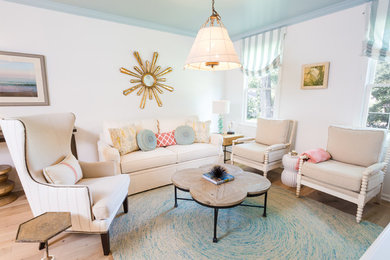 Small beach style formal open concept living room in DC Metro with white walls, light hardwood floors, a freestanding tv and no fireplace.