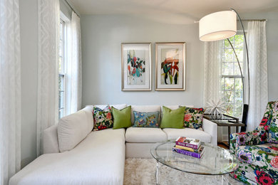 Mid-sized transitional enclosed light wood floor and brown floor living room photo in Charlotte with blue walls
