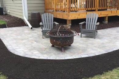 This is an example of a mid-sized traditional backyard full sun garden in Minneapolis with a fire feature and concrete pavers.