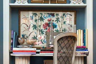 Elegant built-in desk home office library photo in Nashville with blue walls