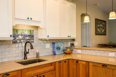 Inspiration for a mid-sized coastal l-shaped beige floor and laminate floor enclosed kitchen remodel in Other with a single-bowl sink, white cabinets, granite countertops, gray backsplash, subway tile backsplash, stainless steel appliances, a peninsula and shaker cabinets