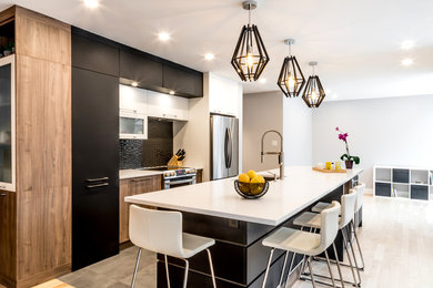 Eat-in kitchen - mid-sized modern single-wall porcelain tile and gray floor eat-in kitchen idea in Montreal with an undermount sink, flat-panel cabinets, black cabinets, quartz countertops, black backsplash, mosaic tile backsplash, stainless steel appliances and an island