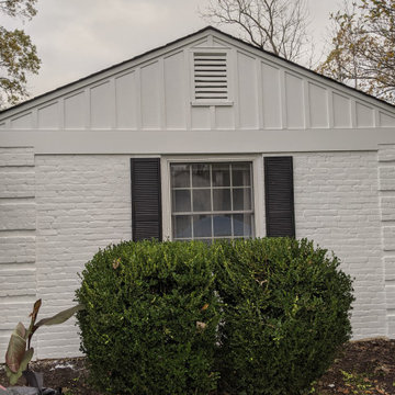 Board and Batton siding on an older brick home