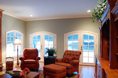 Inspiration for a mid-sized transitional formal and enclosed light wood floor living room remodel in Boston with green walls, no fireplace and no tv