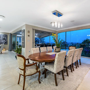 Transitional open plan dining in Brisbane with beige walls and beige floor.