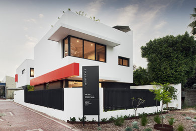 Photo of a contemporary two-storey white house exterior in Perth with a flat roof and a metal roof.