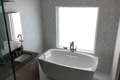 Inspiration for a mid-sized contemporary master white floor bathroom remodel in Tampa with flat-panel cabinets, brown cabinets, white walls, an undermount sink, a hinged shower door and black countertops