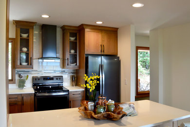 Inspiration for a mid-sized transitional u-shaped ceramic tile and beige floor eat-in kitchen remodel in Other with a farmhouse sink, recessed-panel cabinets, medium tone wood cabinets, quartz countertops, white backsplash, porcelain backsplash, stainless steel appliances, an island and white countertops