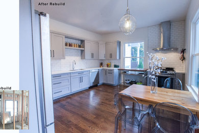 Eat-in kitchen - mid-sized traditional l-shaped dark wood floor eat-in kitchen idea in New York with an undermount sink, shaker cabinets, gray cabinets, quartz countertops, white backsplash, ceramic backsplash, stainless steel appliances and no island