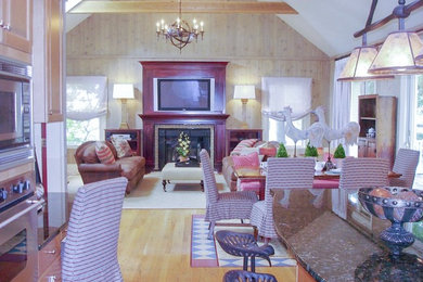 Family room - traditional family room idea with a wood fireplace surround
