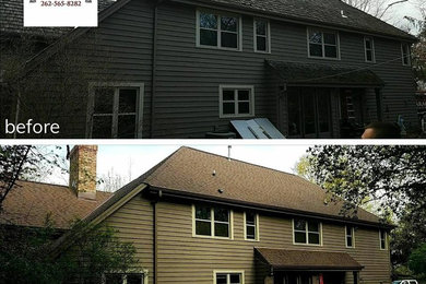 Example of a mid-sized classic brown two-story wood exterior home design in Milwaukee with a shingle roof