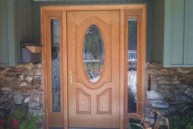 Large 1960s entryway photo in Chicago with a light wood front door
