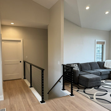 Hallway to Living Room with Light Beige Walls and Black Cable Railing
