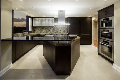 Photo of a contemporary kitchen in Jacksonville with mosaic tile splashback and stainless steel appliances.