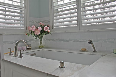 Inspiration for a mid-sized timeless master white tile and subway tile marble floor bathroom remodel in New York with white cabinets, blue walls, marble countertops and a hinged shower door