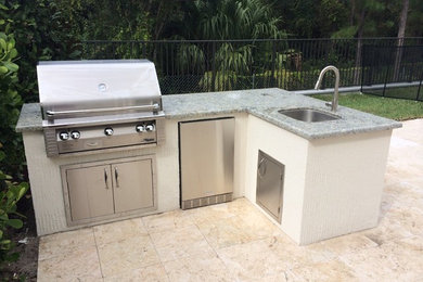 Large elegant backyard patio kitchen photo in Miami with no cover