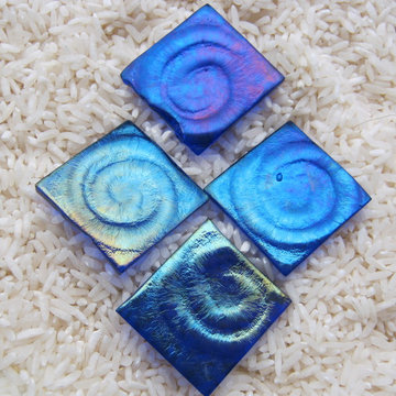 Spiral texture tiles are created individually and slumped over hand carved textu