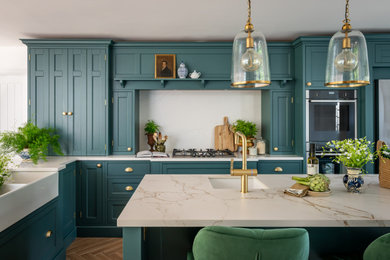 Design ideas for a large classic l-shaped kitchen in Other with a belfast sink, shaker cabinets, blue cabinets, quartz worktops, white splashback, engineered quartz splashback, medium hardwood flooring, an island and white worktops.