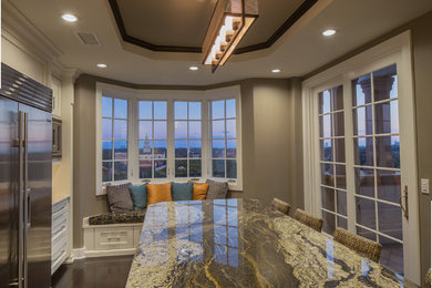 Large trendy galley dark wood floor eat-in kitchen photo in Orlando with a drop-in sink, beaded inset cabinets, white cabinets, granite countertops, stainless steel appliances and an island