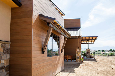 Large trendy brown one-story mixed siding house exterior photo in Denver with a metal roof