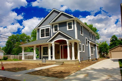 Example of a classic blue two-story vinyl exterior home design in Detroit with a shingle roof