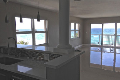 Mid-sized island style open concept porcelain tile and white floor family room photo in Miami with white walls, no fireplace and no tv