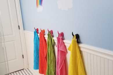 Mid-sized eclectic gender-neutral laminate floor toddler room photo in Chicago with blue walls
