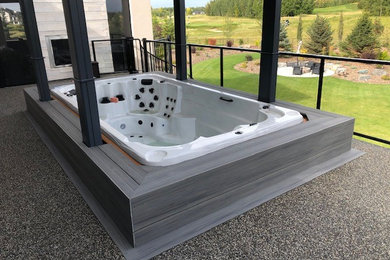 Small minimalist backyard rectangular aboveground hot tub photo in Edmonton with decking