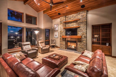 Photo of a large country formal open concept living room in Other with beige walls, a standard fireplace, a stone fireplace surround and a wall-mounted tv.