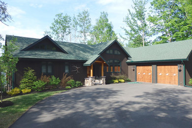 Example of a large mountain style brown two-story wood exterior home design in Burlington with a hip roof