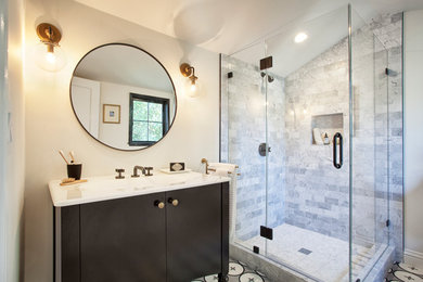 Example of a transitional 3/4 black and white tile and stone tile concrete floor corner shower design in San Francisco with black cabinets, a two-piece toilet, white walls, an integrated sink and solid surface countertops