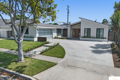 Example of a mid-sized gray floor entryway design in Orange County