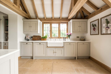This is an example of a classic kitchen in Sussex with shaker cabinets and an island.