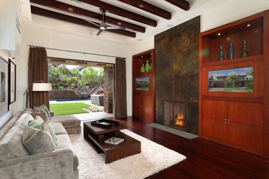 Photo of a large contemporary open concept family room in Orange County with dark hardwood floors, a standard fireplace, a metal fireplace surround, a built-in media wall and white walls.